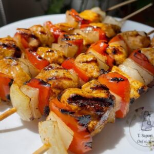 Chicken breast skewers topped with caramelized onions.